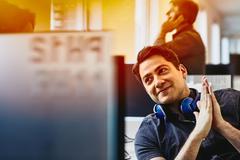 Photo of a man looking at his computer screen