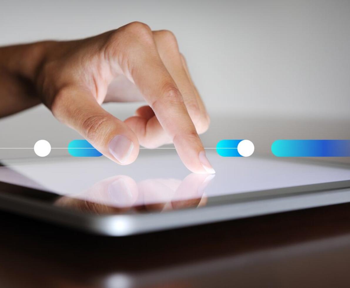 Natural manicured finger pointing on a digital tablet