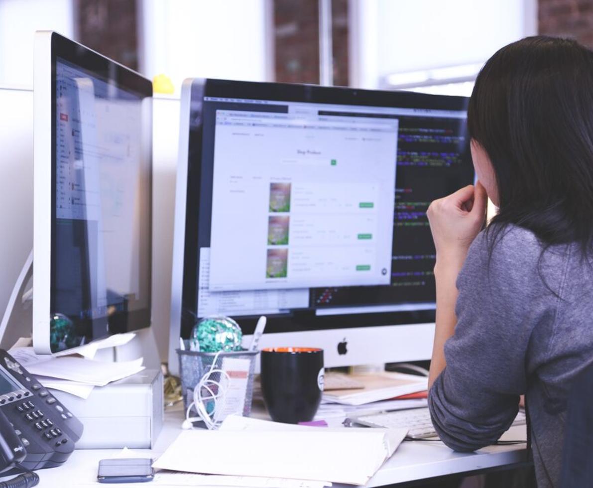 woman sitting at computer, view from behind