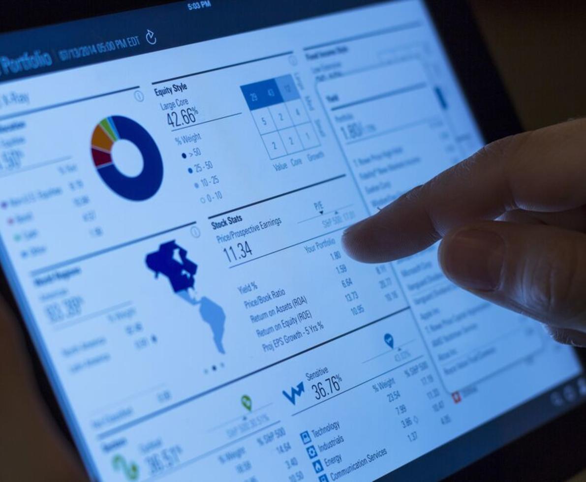 touch screen with finger pointing at metrics