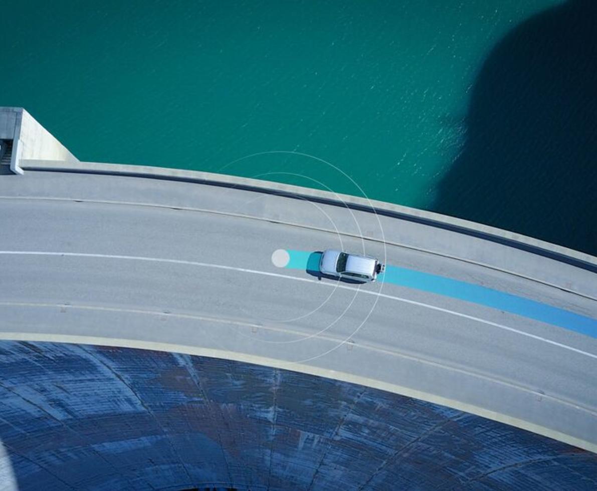 car driving on road with blue line
