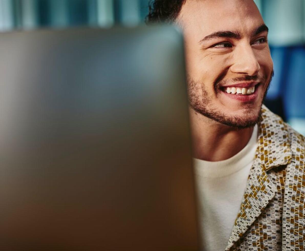 Close up of man looking away from his computer screen