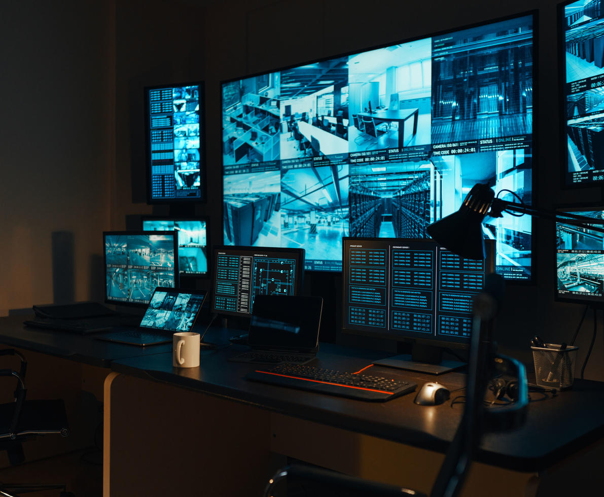 A security workplace with a modern high-tech control panel in the form of large monitors that display real-time information from external video surveillance cameras